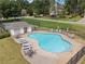 Aerial view of a community pool and tennis court with lounge chairs, tables, and a clubhouse, surrounded by a fence at 5013 Kendall Nw Sta, Acworth, GA 30102