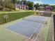 A community tennis court with a basketball hoop is surrounded by green foliage, neighborhood homes and a bath house at 5013 Kendall Nw Sta, Acworth, GA 30102