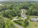 Sprawling estate with manicured lawns, mature trees, and a pristine home in a private, wooded setting at 590 Arthur Rd, Canton, GA 30115