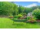 Lush backyard with a swing set and decorative pond, showcasing landscaping and serene atmosphere at 590 Arthur Rd, Canton, GA 30115