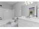 Clean, well-lit bathroom with white fixtures and tiled floor at 590 Arthur Rd, Canton, GA 30115