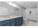 Modern bathroom with a double sink vanity, a large mirror, and a glass-enclosed shower at 590 Arthur Rd, Canton, GA 30115