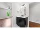 Half bathroom featuring dark cabinet, white countertop and access to bright bedroom at 590 Arthur Rd, Canton, GA 30115