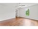 Bright bedroom with hardwood floors, ceiling fan, and large picture window at 590 Arthur Rd, Canton, GA 30115