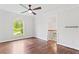 Bright bedroom boasts hardwood floors, arched window, ceiling fan, and adjacent hall access at 590 Arthur Rd, Canton, GA 30115