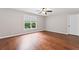 Bright, empty bedroom featuring a window providing natural light and hardwood floors at 590 Arthur Rd, Canton, GA 30115