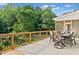 Spacious deck with outdoor dining area, offering scenic views and a seamless transition to screened in porch at 590 Arthur Rd, Canton, GA 30115