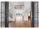 Grand foyer entrance with hardwood floors, iron door and staircase with natural light and open floorplan at 590 Arthur Rd, Canton, GA 30115