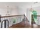 Elegant foyer with hardwood flooring, ornate iron railing, and decorative lighting at 590 Arthur Rd, Canton, GA 30115