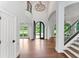 Bright foyer features high ceilings, iron door, and hardwood floors, staircase and plenty of natural light at 590 Arthur Rd, Canton, GA 30115
