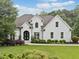 Elegant white brick home with lush green lawn and meticulously maintained landscaping at 590 Arthur Rd, Canton, GA 30115