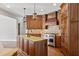 Gourmet kitchen featuring stainless steel appliances, brick backsplash, and custom island at 590 Arthur Rd, Canton, GA 30115
