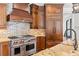 Kitchen featuring a brick backsplash, stainless steel appliances, and granite countertops at 590 Arthur Rd, Canton, GA 30115