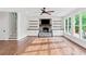 Bright living room with stone fireplace, built-in shelves and cabinet storage, and hardwood floors at 590 Arthur Rd, Canton, GA 30115