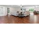 Open-concept living space flows seamlessly into the kitchen and dining area, hardwood floors at 590 Arthur Rd, Canton, GA 30115
