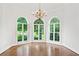Sun-filled formal room with chandelier lighting and arched windows overlooking the yard at 590 Arthur Rd, Canton, GA 30115