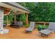 Covered porch with lounge chairs, a swing, and a ceiling fan, ideal for relaxing in the shade at 590 Arthur Rd, Canton, GA 30115