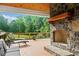 Cozy outdoor area featuring a stone fireplace and comfortable seating, ideal for relaxation and outdoor enjoyment at 590 Arthur Rd, Canton, GA 30115
