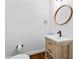 Stylish powder room with hardwood floors, round mirror, and vessel sink at 590 Arthur Rd, Canton, GA 30115