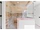 Spacious walk-in shower with pebble tile, seating, and upgraded tile surround at 590 Arthur Rd, Canton, GA 30115