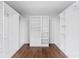 Large walk-in closet with custom shelving and hardwood flooring at 590 Arthur Rd, Canton, GA 30115