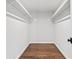 Walk-in closet with hardwood floors and white walls, and shelf storage at 590 Arthur Rd, Canton, GA 30115