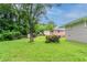 View of the large, grassy backyard with mature trees and green landscape at 933 Capitol View Nw Ave, Atlanta, GA 30318