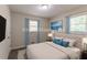 A modern staged bedroom featuring blue accents and natural light creates a relaxing atmosphere at 933 Capitol View Nw Ave, Atlanta, GA 30318