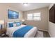 This staged bedroom has modern decor, including blue accents and a serene art piece, creating a relaxing atmosphere at 933 Capitol View Nw Ave, Atlanta, GA 30318