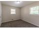 A bright bedroom with neutral walls, plush carpet, and two windows offering natural light creates a welcoming atmosphere at 933 Capitol View Nw Ave, Atlanta, GA 30318