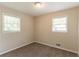 A bright bedroom featuring neutral walls, plush carpet, and two windows offering natural light creates a welcoming atmosphere at 933 Capitol View Nw Ave, Atlanta, GA 30318