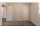 A clean bedroom with neutral walls and plush carpet flows into wood flooring visible through an open doorway at 933 Capitol View Nw Ave, Atlanta, GA 30318