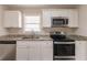 Modern kitchen featuring stainless steel appliances, granite countertops, and white cabinetry at 933 Capitol View Nw Ave, Atlanta, GA 30318