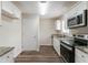 Modern kitchen featuring stainless steel appliances, granite countertops, and wood flooring at 933 Capitol View Nw Ave, Atlanta, GA 30318