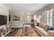 This staged living room is furnished with a sofa, ottoman, and television set at 933 Capitol View Nw Ave, Atlanta, GA 30318