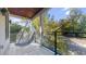 A covered balcony featuring a bubble chair and views of mature trees at 1099 Vista Ne Trl, Atlanta, GA 30324