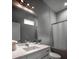 This bathroom features a white vanity, a large mirror, and a bathtub with shower at 1099 Vista Ne Trl, Atlanta, GA 30324