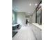 Elegant bathroom featuring a glass shower, standalone tub, and white tile floors at 1099 Vista Ne Trl, Atlanta, GA 30324