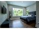 Bedroom with a large window offering a view of the outdoors, dark wood floors, and modern decor at 1099 Vista Ne Trl, Atlanta, GA 30324