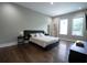 Bedroom featuring hardwood floors, a queen bed, and an en suite bathroom at 1099 Vista Ne Trl, Atlanta, GA 30324
