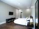Bedroom featuring hardwood floors, a queen bed, a TV, and an en suite walk-in closet at 1099 Vista Ne Trl, Atlanta, GA 30324