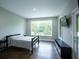Bedroom with natural light, dark hardwood floors and views of the trees outside at 1099 Vista Ne Trl, Atlanta, GA 30324