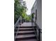 Outdoor deck with glass railings, dark wood, and an outdoor grill and seating area at 1099 Vista Ne Trl, Atlanta, GA 30324