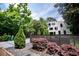 Modern two-story home featuring a horizontal wood fence and lush landscaping at 1099 Vista Ne Trl, Atlanta, GA 30324