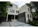 Modern two-story home featuring sleek lines, a glass garage door, and a contemporary design at 1099 Vista Ne Trl, Atlanta, GA 30324