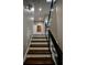 Staircase features hardwood steps with modern glass and metal railings and leads to a hallway at 1099 Vista Ne Trl, Atlanta, GA 30324