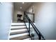 Stylish staircase featuring dark wood steps, white risers, and a sleek black metal and glass railing at 1099 Vista Ne Trl, Atlanta, GA 30324