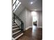 Modern stairway with hardwood steps, glass railing, and natural light at 1099 Vista Ne Trl, Atlanta, GA 30324