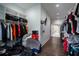 Spacious walk-in closet featuring custom shelving, hanging rods, and hardwood flooring at 1099 Vista Ne Trl, Atlanta, GA 30324