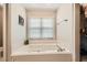 Bright bathroom featuring a soaking tub with jacuzzi jets and closet at 1652 Tryon Ne Rd, Atlanta, GA 30319